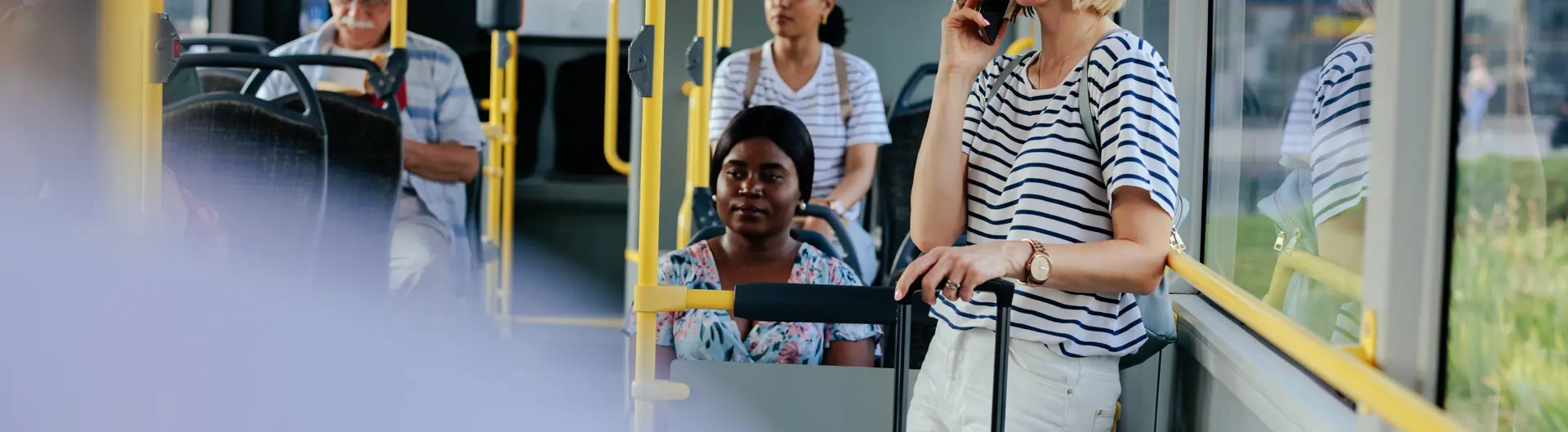 Lady holding luggage on a bus